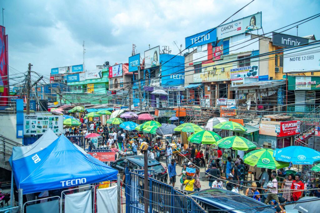 Crowded market street with umbrellas in Lagos, Nigeria