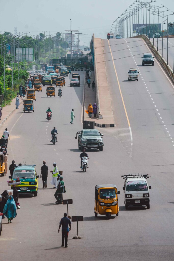 Pedestrians and traffic on a bright street in Lagos, Nigeria