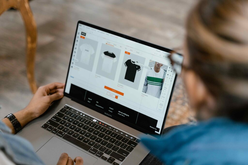 Two people work together over a laptop, looking at the screen as they compare options